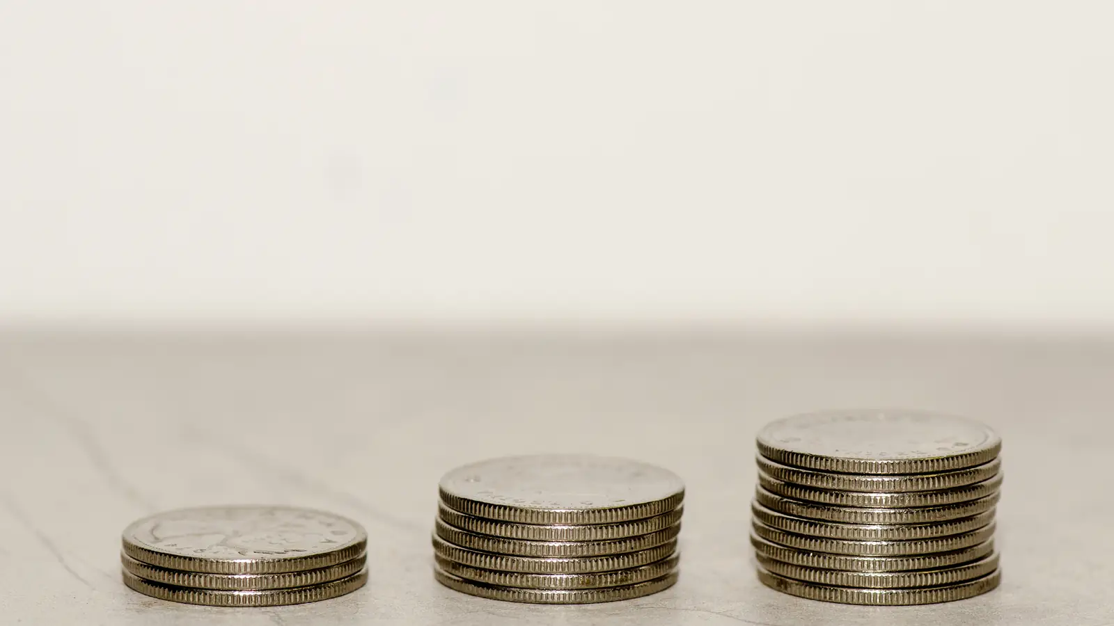 Three stacks of coins growing taller from left to right