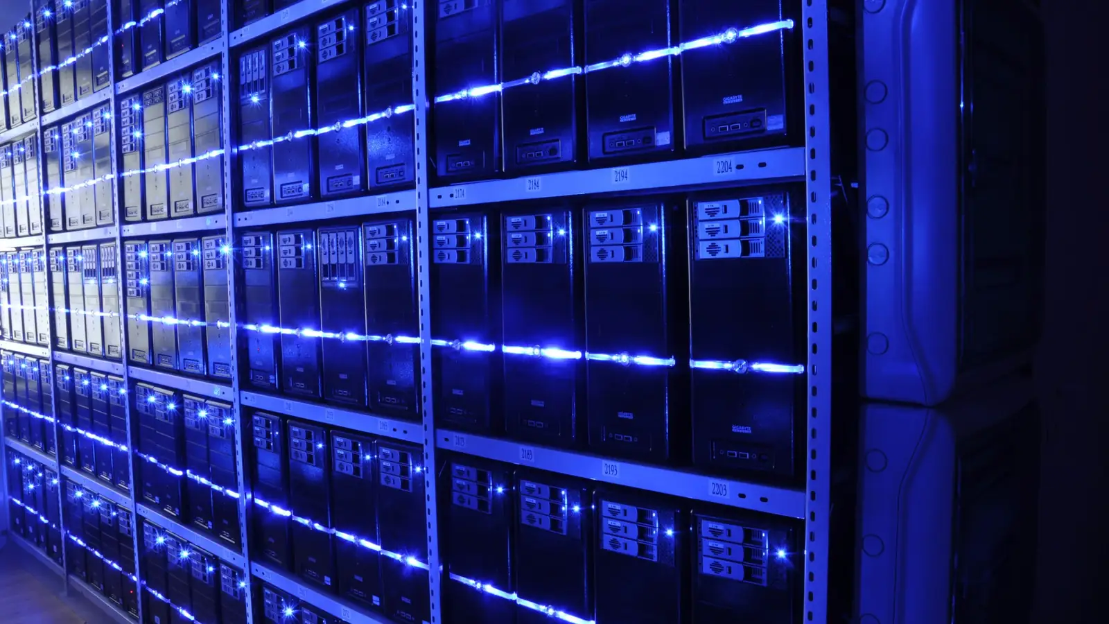 Rows of servers glowing blue in a data centre