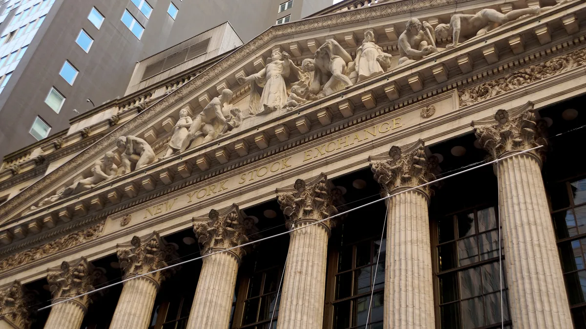 The columns and sculpted pediment of the New York Stock Exchange building on Broad Street, seen from street level