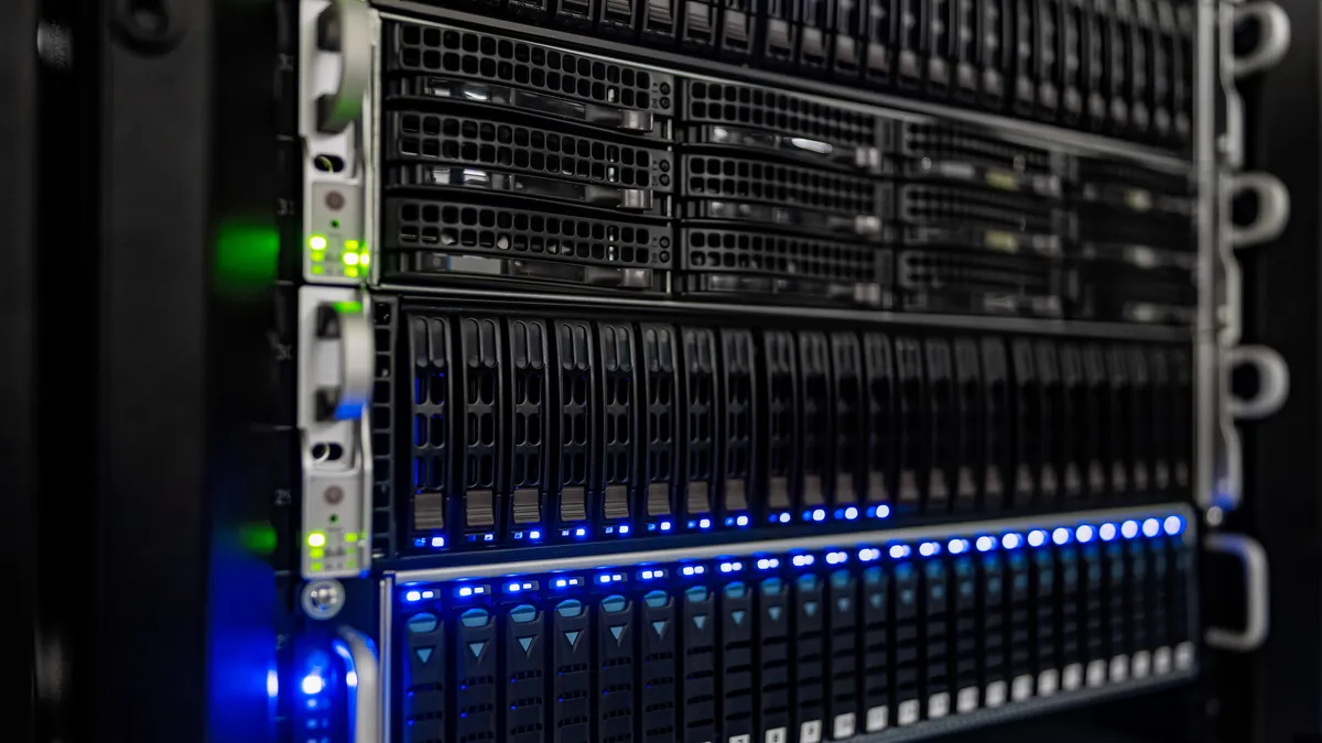 Close-up of a server rack with rows of drive bays lit by small blue and green status lights