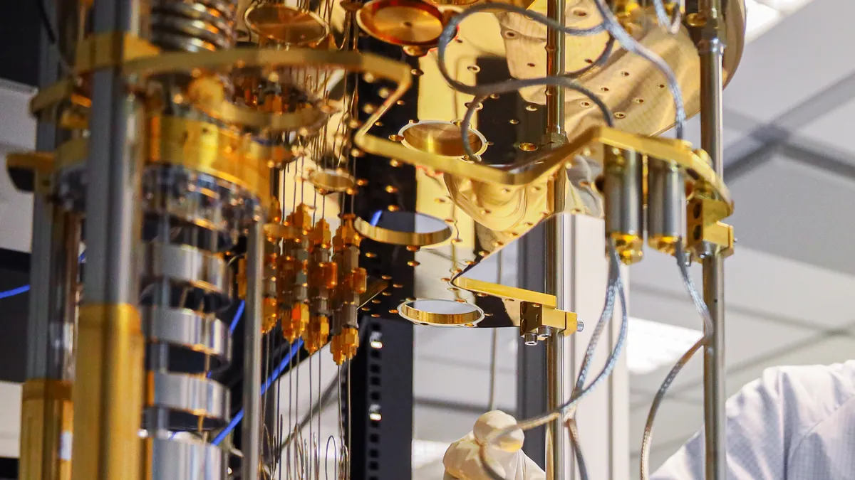 Close-up of the gold-plated stages and cabling of a dilution refrigerator, the cooling system that holds superconducting quantum processors near absolute zero
