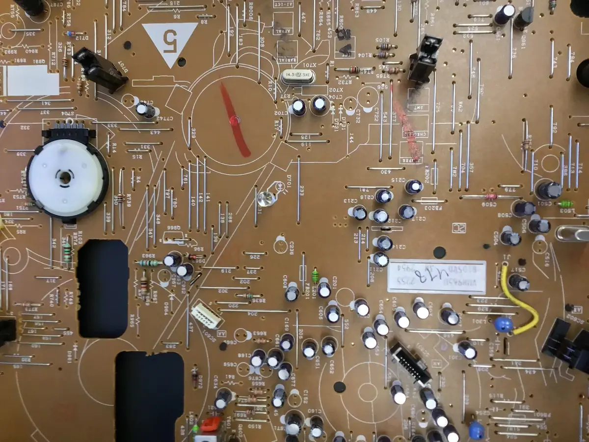 A close-up of a green circuit board covered in small electronic components