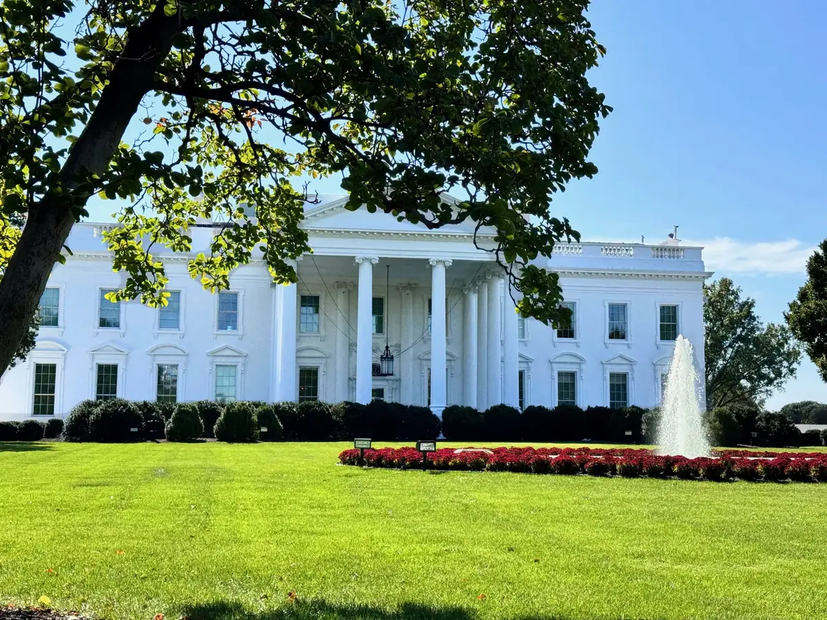The north facade of the White House with a fountain and a flower bed in front